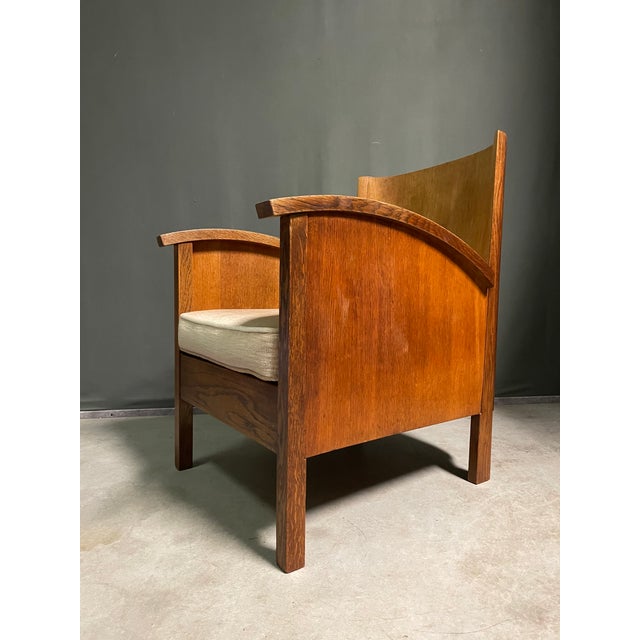 A nicely proportioned small armchair with sweeping armrests and curved back. Seat cushion has some user marks. This piece...