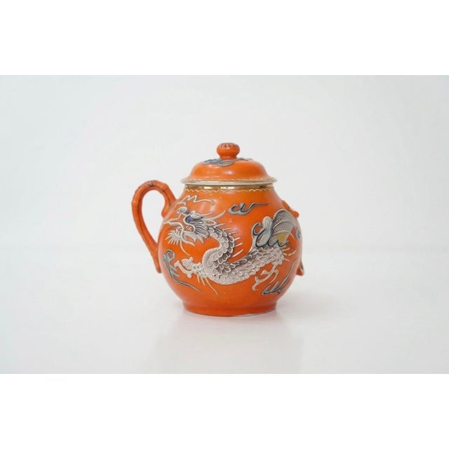 This rare, expanded 23-piece service for five is a masterclass in Mid-Century Japanese Chinoiserie. Featuring a bold...