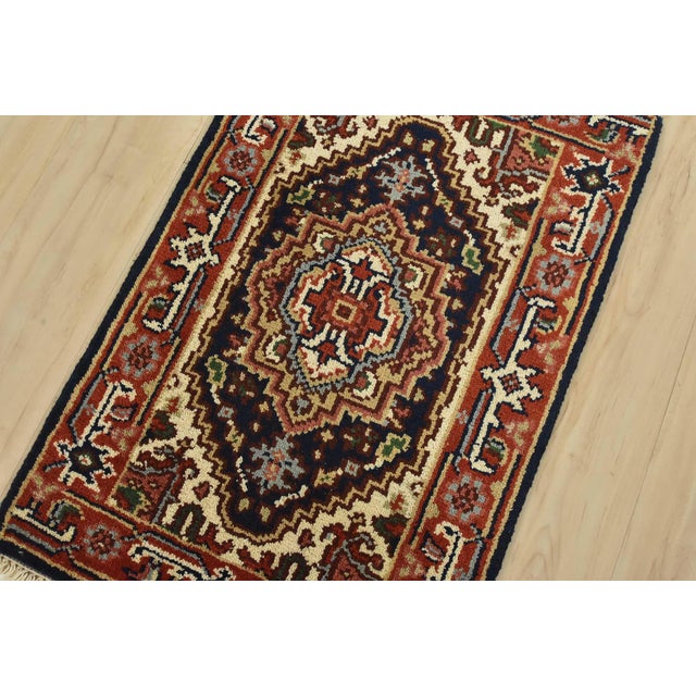 A traditional tribal Heriz rug hand-knotted with fine wool on a cotton foundation. This oriental rug features a central...