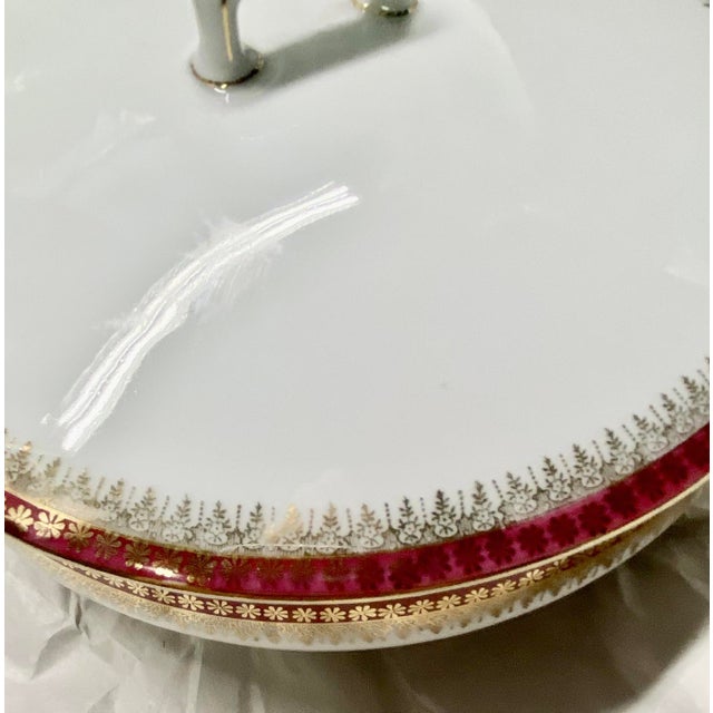 Carlsbad China of Czechoslovakia. The color is a brick red with gilt-edged filigree.. A set of 62 pieces of porcelain...