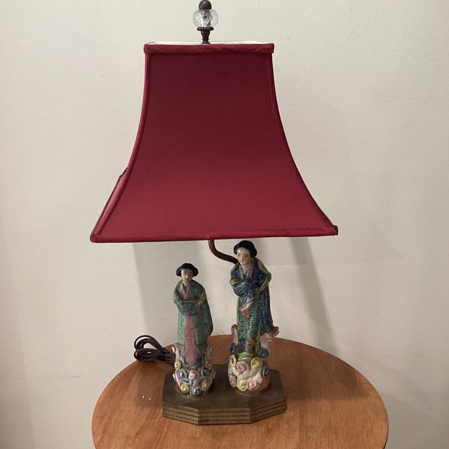 The Chinoiserie Porcelain Figural Table Lamp on Brass Base in Famille Rose Palette is a luxurious and decorative lighting...