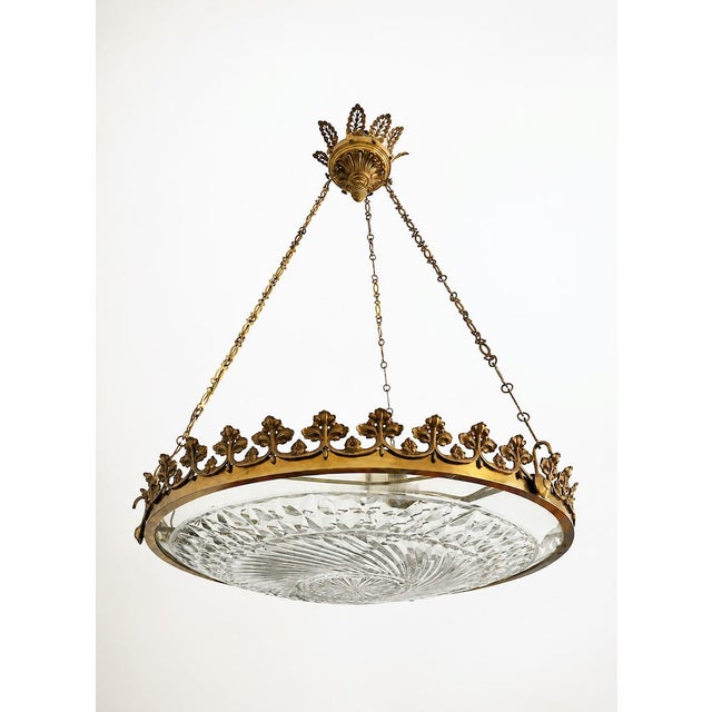 Italian pendant chandelier, mid-19th century, in chiseled gilt metal and faceted crystal. Circular structure with rich...