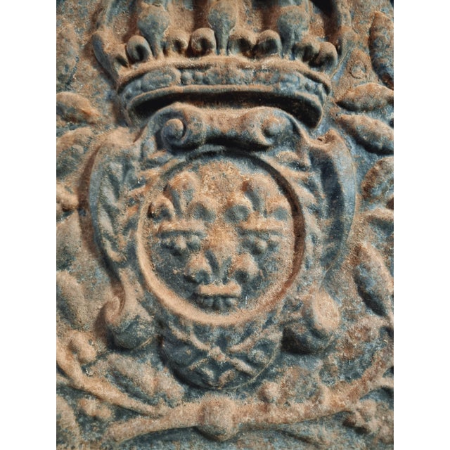 This antique french cast iron fireback dates from the late 17th century and originates from the auvergne region in france....