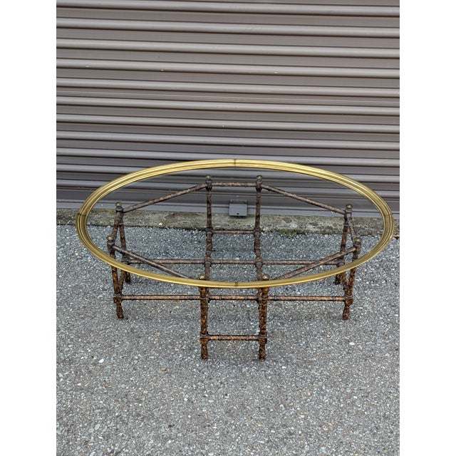 Oval brass tray over a tortoise-lacquered faux bamboo base in the unmistakable Baker idiom. The oval is the scarcer form...