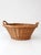 A vintage woven gathering basket with a softly rounded, low open form and integrated side handles. Crafted in natural...