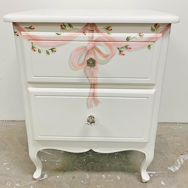 Bring a touch of romance to your bedroom with the Anabelle Night Stand, exquisitely finished in soft white and detailed...