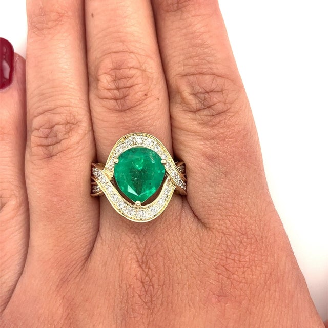 Art Deco-inspired natural emerald and diamond ring in 14k solid gold. Gemstones are stationed on a stunning split shank...