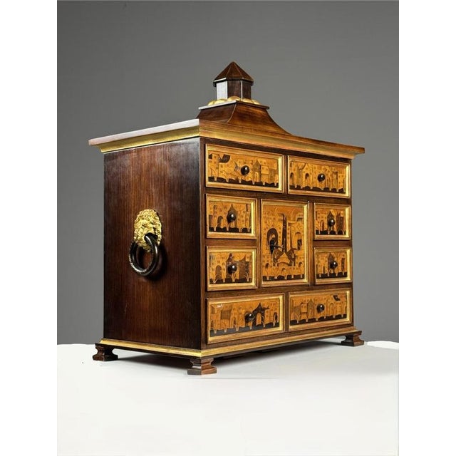 Small art cabinet with architectural marquetry, 18th century. Small table cabinet veneered with mahogany, with nine...