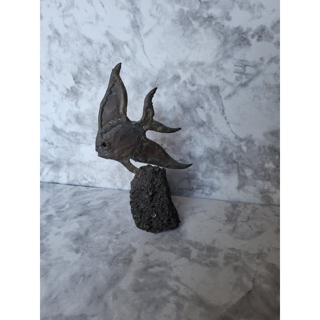 A delightful heavy and well cast bronze angel fish in bronze. It is cast on a pourous lava stone depicts the fish gliding...