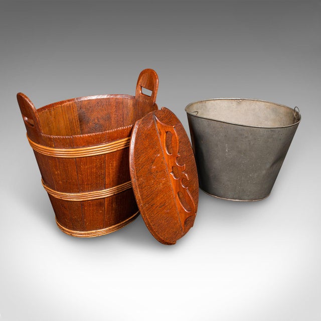 This is a fine antique Georgian period lidded waste bin, presenting as a distinguished Dutch fireside store in oak and...