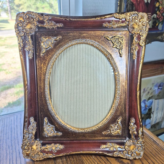 This vintage ornate gold gilt picture frame in a Victorian revival style features an oval opening measuring 8x10 inches,...