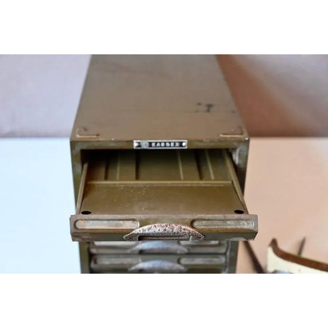 This small storage unit with a undoubtedly industrial style was used to storage sheets and other documents. Stamped Kardex...