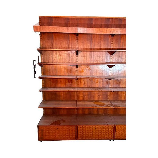 This sophisticated and rare teak wall system features geometric marquetry fronts reminiscent of early Poul Cadovius Royal...