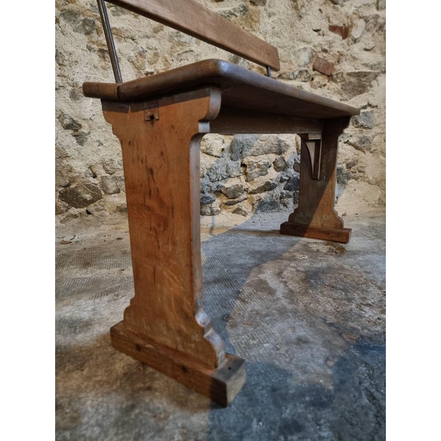 This vintage French wooden bench dates from the 1920s and is crafted from solid beechwood. The bench features a restrained...