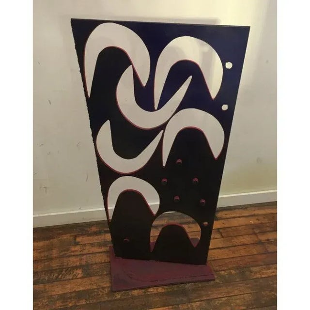 Vintage iron abstract sculpture on base with cutout shapes. Sculpture has a painted surface, featuring contrasting colors.