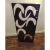 Vintage iron abstract sculpture on base with cutout shapes. Sculpture has a painted surface, featuring contrasting colors.