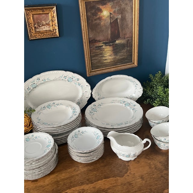 An elegant mid-century dinner service by Royal Jackson, rendered in fine English bone china and decorated with a...