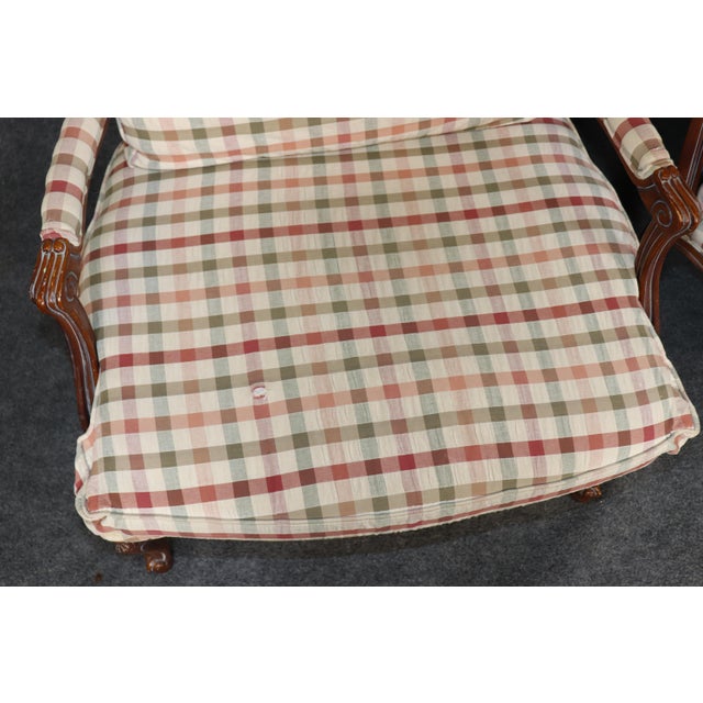 Elegant, inviting, and beautifully handcrafted, this exceptional pair of French Louis XV style walnut fauteuil lounge...