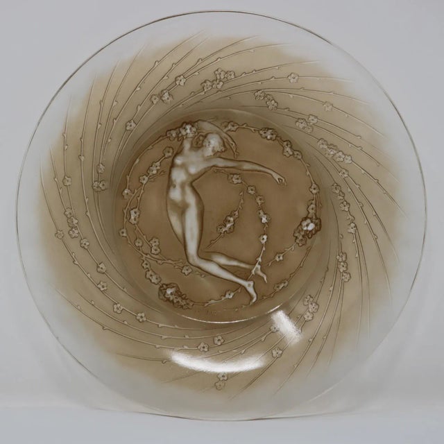 Rene Lalique clear and frosted glass, 'Une Figurine et Fleurs' plate. Sepia-stained details. This pattern features a naked...