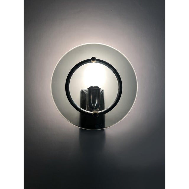 Pair of Italian wall lights in transparent bluish gray glass and chrome from the 70s Shine and transparency for this very...