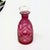 Cranberry decanters with stoppers, group of 3. Group of fuchsia pink and transparent glass decanters and with rounded...