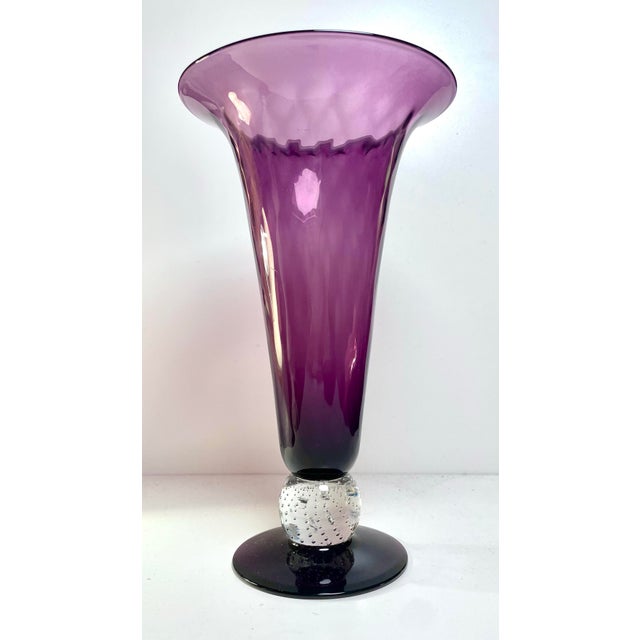 Stunning purple vase with a diamond optic pattern and trumpet vase shape. This vase sits on a clear bowl stem with...