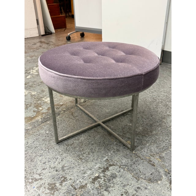 Design Plus Gallery presents the Jonathan Stool from Oly Studio. The circular seat is upholstered in lavender-toned fabric...
