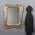 Gilded wood mirror featuring faux silver and faux gold leaf workmanship, enriched with painted floral details positioned...