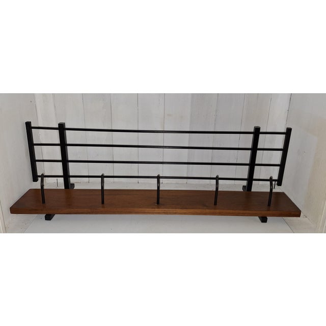 Vintage Wall-Mounted Coat Rack with Black Metal and Teak Wood Strip, 1970s, in Very Good conditions. Designed 1970 to 1979