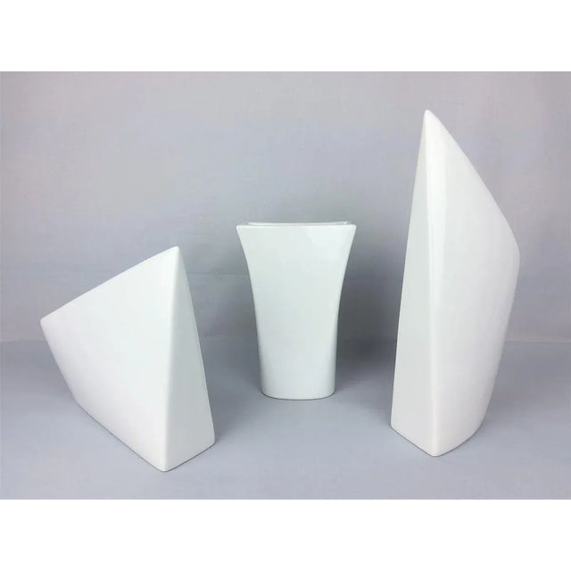 Set of three vases 1960. Triangular and rectangular white porcelain. Crack on one of the vases, pictured. Vase 1: Height...