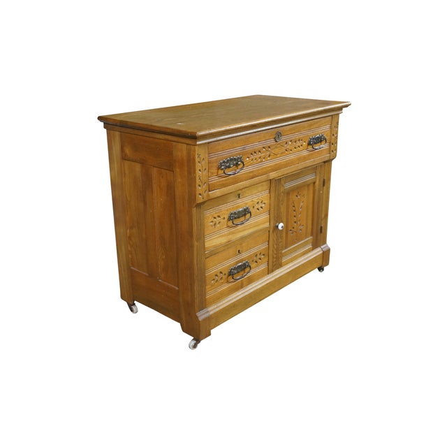 An antique Victorian era oak washstand, bedside chest or cabinet. Features a solid oak construction with a warm golden...