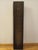 This decorative wall sculpture features a finely carved female figure in flowing classical robes, rendered in rich warm...