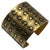 Gold-plated COCO bracelet cuff. This cuff is adorned with gold-tone metal and black enamelled lettering reading "COCO"...