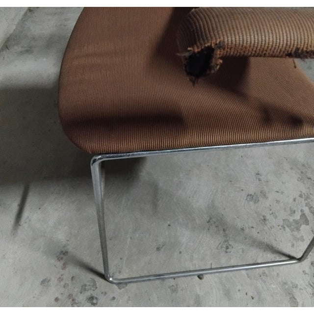 Stainless steel rod chair with padded seat, backrest, and armrests. Made by Bononia Gavina. Minimalist and functional...