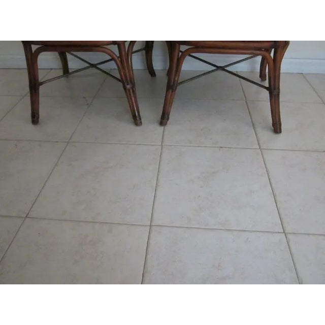 Introducing a set of four stylish dining chairs from the Tommy Bahama collection. These chairs feature upholstered seats...