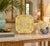Elegant octagonal porcelain tray featuring a soft pale yellow ground with intricate gilt decoration throughout. The design...