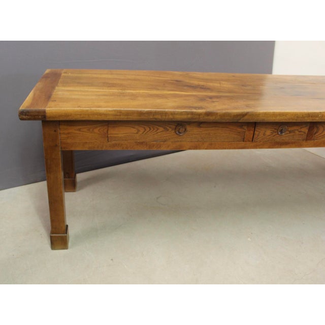 A walnut farmhouse table with three drawers in the apron; the tabletop is walnut and the drawers are original ash; seats...