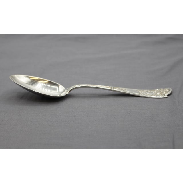 Late 19th century "Cupid" pattern sterling silver serving spoon, American. 1878 patent design of Morgan Morgans, Jr., and...