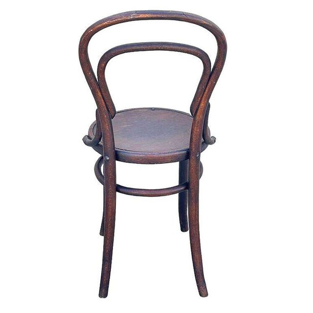 Late Victorian Thonet number 14 side chair features an elegant, sculptural frame crafted from warm-toned bentwood with...