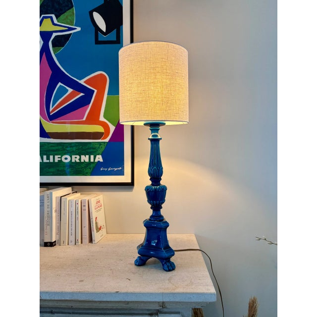 Turquoise-glazed ceramic lamp base in the shape of a column, resting on three lion’s paws. Signed “Pol Chambost” on the...
