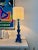 Turquoise-glazed ceramic lamp base in the shape of a column, resting on three lion’s paws. Signed “Pol Chambost” on the...