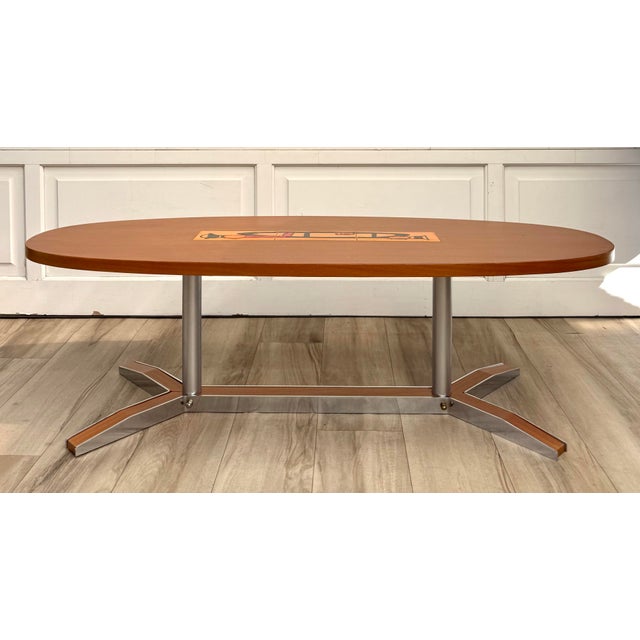 Here is a wonderful Mid-Century Modern oval coffee table, dating to the 1960s. The elongated oval top features warm wood...