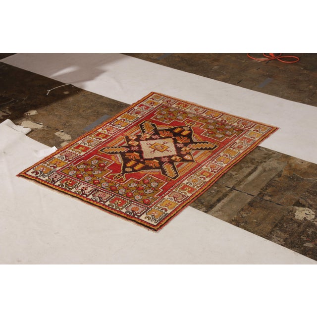 Hand-knotted in wool originating from Turkey circa 1910-1920, this antique rug connotes a transitional Kirsehir rug...