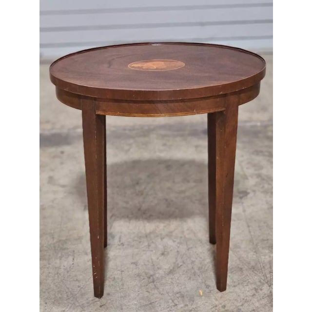 Store Item: Baker Mahogany Federal Style Shell Inlay Occasional Table Description: Table features a solid mahogany oval...