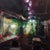 This oil painting captures the intimate ambiance of a café, where soft, blended colors create a dreamlike atmosphere. The...