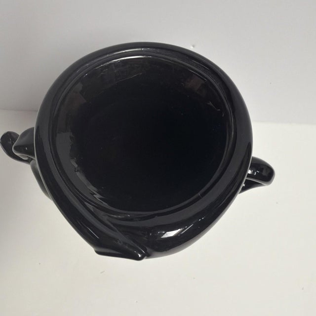 Beautiful hand-blown black art glass vase with two applied handles and a classic pontil mark on the base indicating hand...