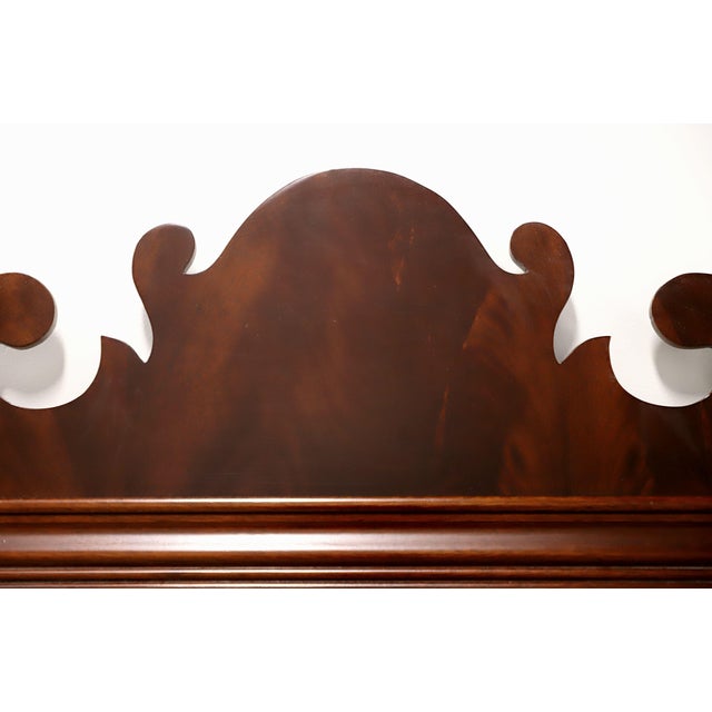 A large Chippendale style wall mirror by Councill Craftsmen. Bevel edge mirrored glass in a mahogany frame with fluted...