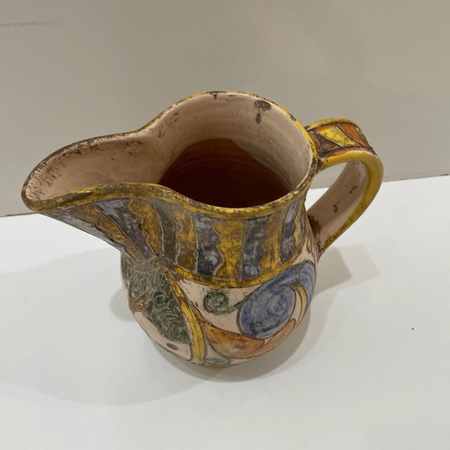 Vintage hand created ceramic pitcher with heavy engraved design detail. Look for the cool bird. Great for that ceramic lover