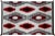 A striking early 20th century Navajo blanket with a bold all-over diamond pattern woven in crimson, white, gray, and black...