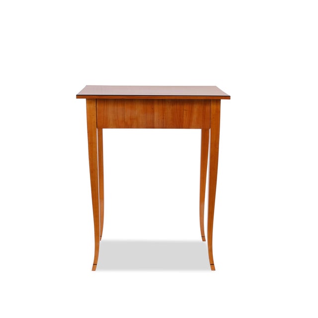 This Biedermeier side table, dating from around 1820, was crafted in Germany from cherry wood. Its construction is...